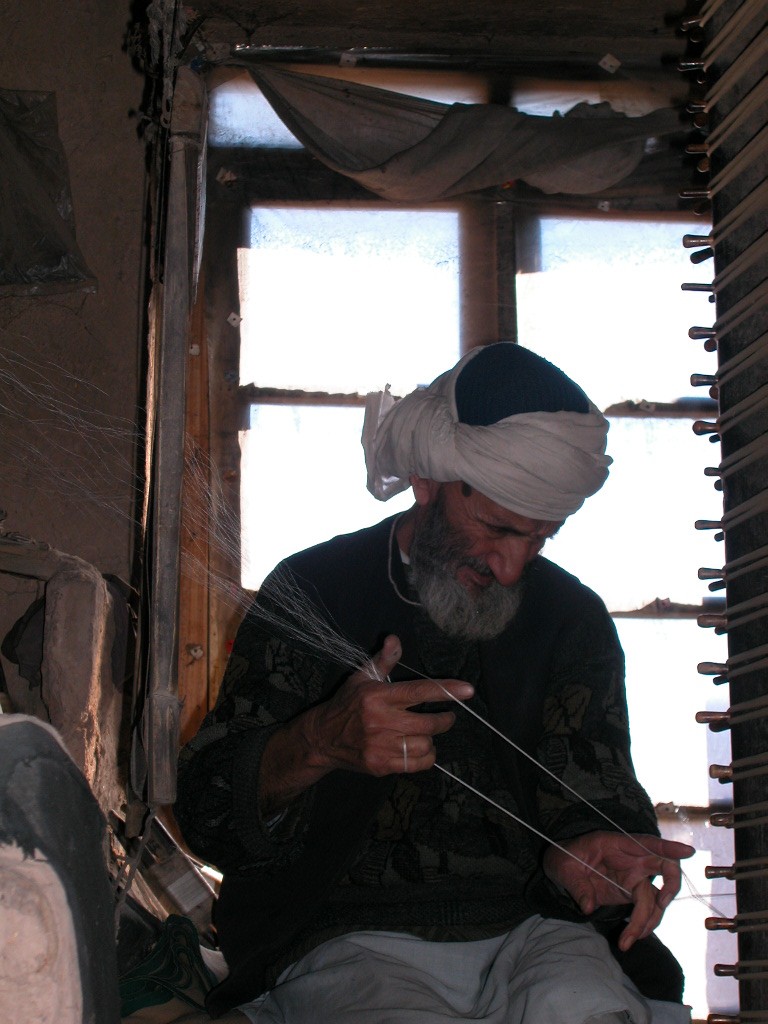 Arghand artisan is reeling silk yarn
