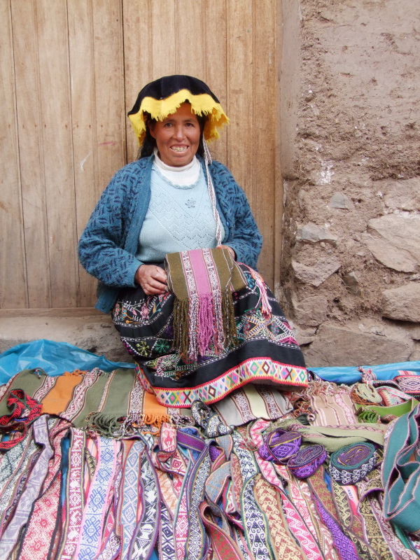 Artisan shows her alpaca wool scarves at Pisaq market