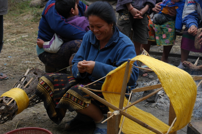 Artisan in Lao village is reeling mulberry silk
