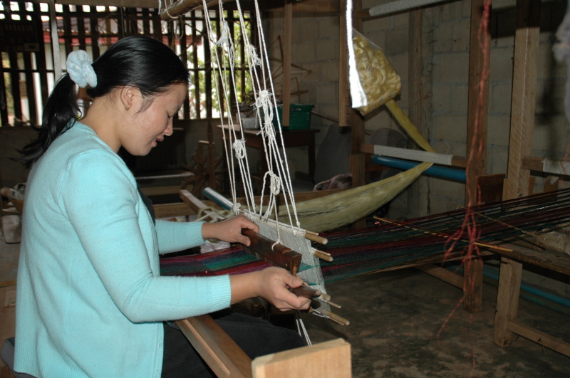 Artisan is weaving a silk scarf for Counting Flowers