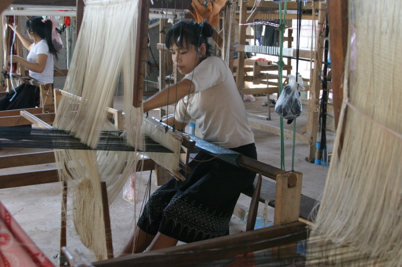 Artisan is weaving silk scarves