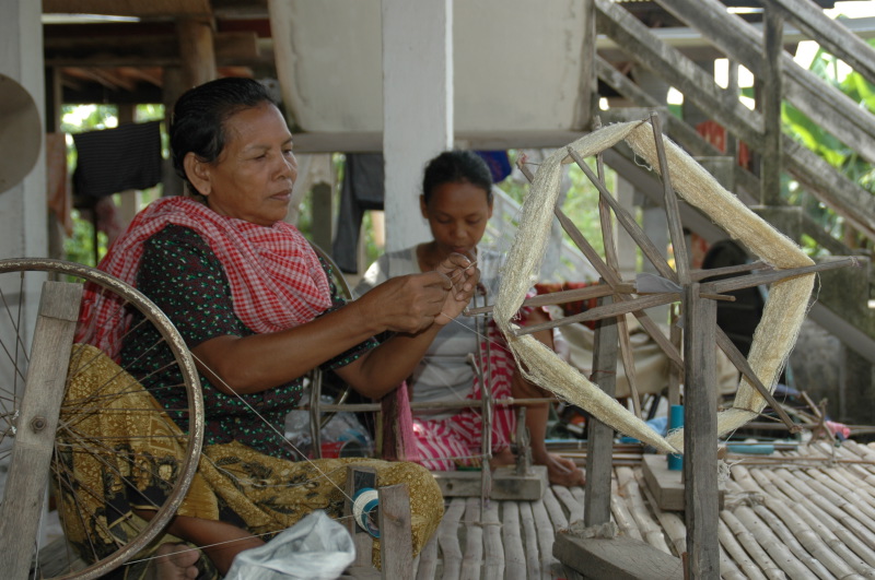 Somneang and her mother are reeling silk yarn