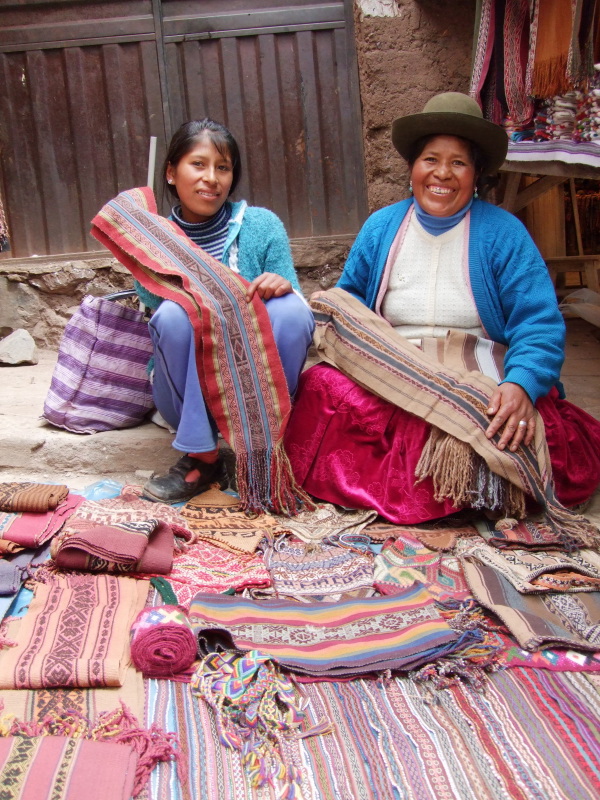 Artisans show their handwoven alpaca wool scarves
