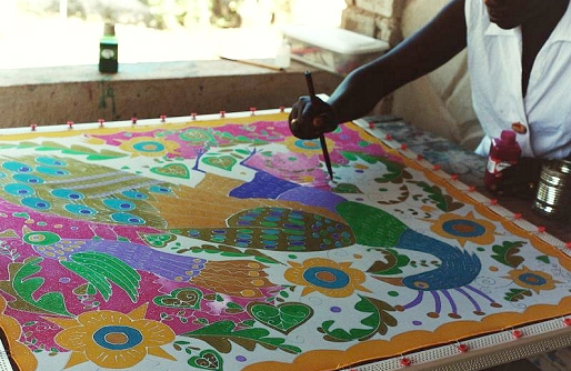 Atis fanm artisan painting a silk scarf
