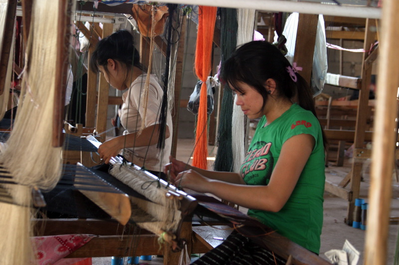 Phonesouk's artisans are weaving silk scarves