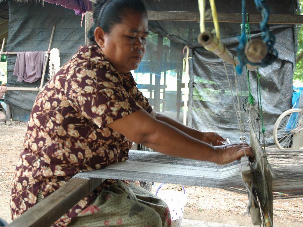 Artisan weaving an eri silk scarf